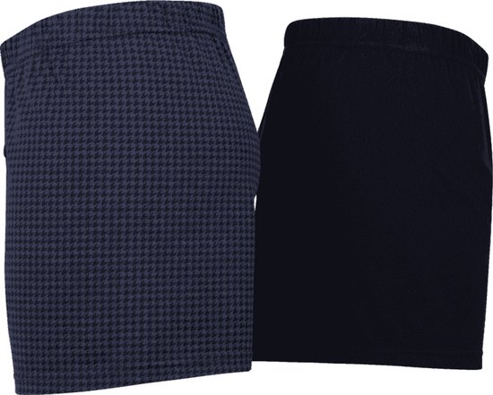 Twee Ceceba boxershorts, een met marineblauw pied-de-poule patroon en een effen marineblauwe variant.