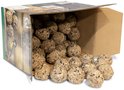 Kartonnen doos met vetbollen die eruit rollen op een witte ondergrond.