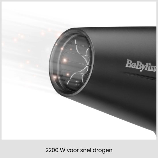 Gros plan de la sortie d'air du sèche-cheveux noir, puissance de 2200 W pour un séchage rapide.