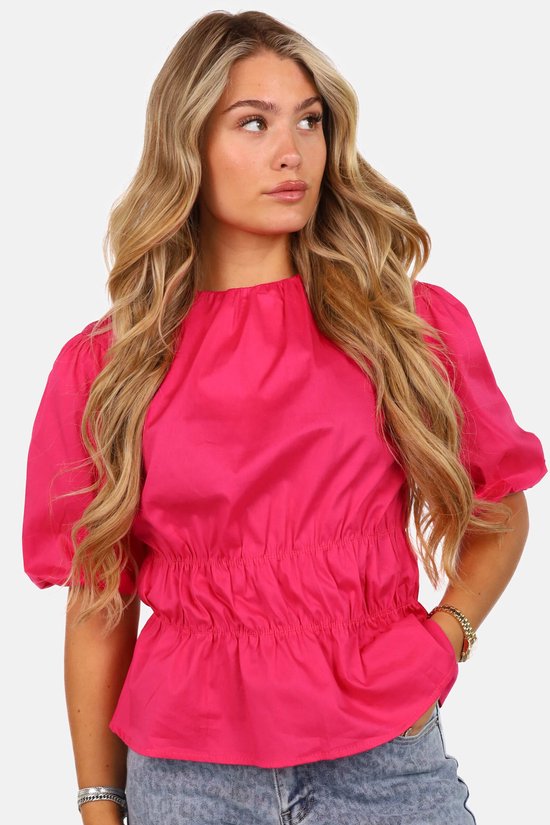 Getdrezzed top in fuchsia met pofmouwen en een gesmokte taille, van voren gefotografeerd.