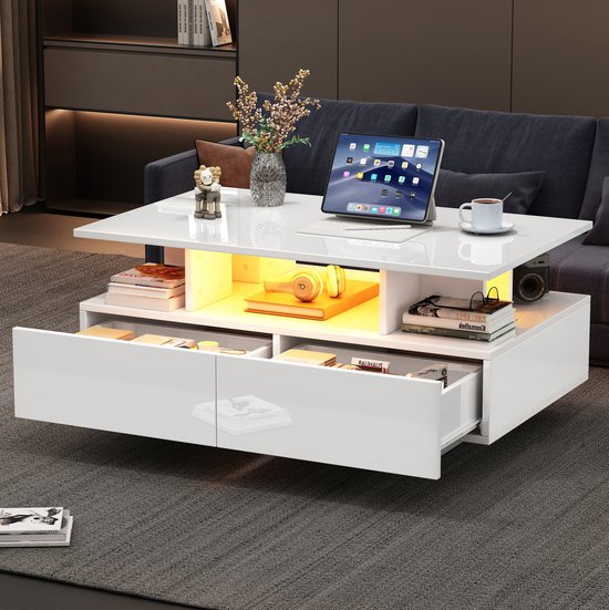Witte salontafel met geopende lades, sfeervolle LED-verlichting en decoratie op het tafelblad.