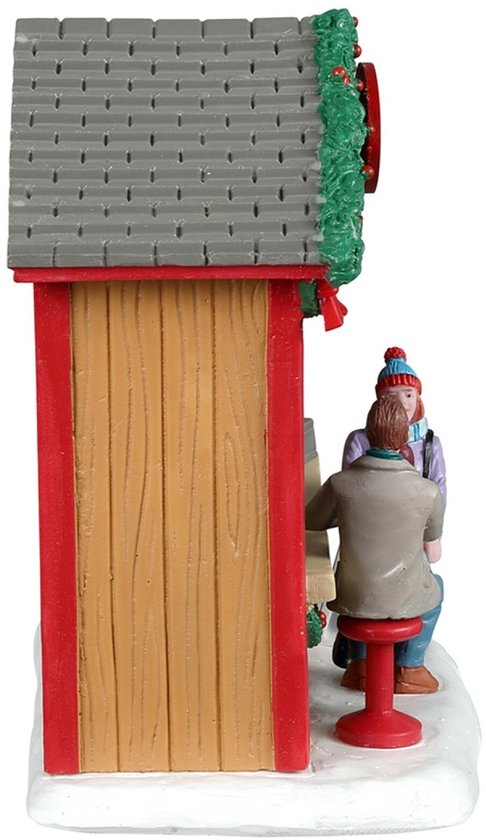 Rechterzijaanzicht van een houten kerstcafé, met klanten op rode krukken, op een besneeuwde ondergrond.