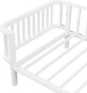 Detail van de hoek van een wit metalen dagbedframe met ronde spijlen.