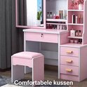 Roze kaptafel met comfortabel kussen op de kruk en opbergplanken voor cosmetica.