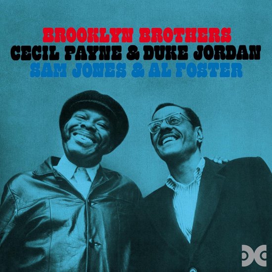 Twee jazzmuzikanten, Cecil Payne en Duke Jordan, glimlachen naar de camera. Ze dragen zwarte pakken en hemden.