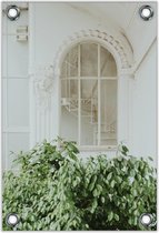 Tuinposter –Wit Gebouw met Groene Struik ervoor– 80x120cm Foto op Tuinposter (wanddecoratie voor buiten en binnen)