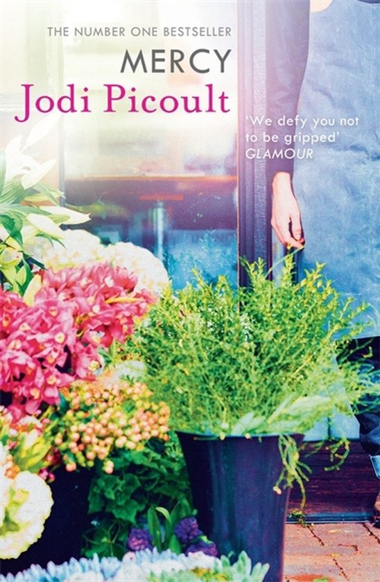 Boekcover van 'Mercy' van Jodi Picoult, met bloemen en tekst 'The Number One Bestseller'.