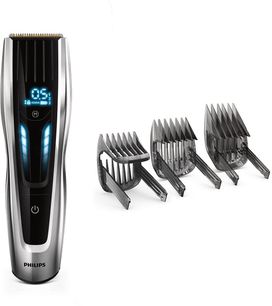 Zilverkleurige Philips tondeuse met display en drie opzetkammen.