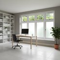 Kantoor met bureau, computer en boekenplanken voor een groot raam met raamfolie.