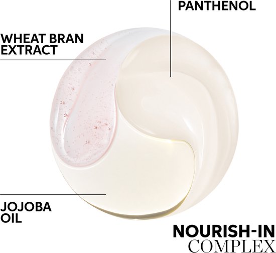 Close-up van een druppel met tarwezemelextract, jojoba-olie en panthenol. Nourish-In Complex.
