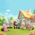 Groep van acht Labubu macaron speelgoedfiguren in konijnenkostuums, buiten spelend met muziek en eten.