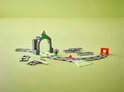 Duplo treintunnel met grijze stenen, groen dak, met spoor en een rood schakelpunt.