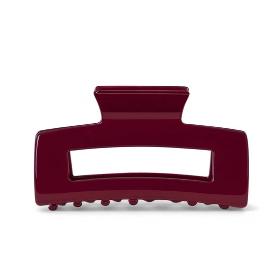 Pince à cheveux bordeaux en acétate avec une ouverture rectangulaire.