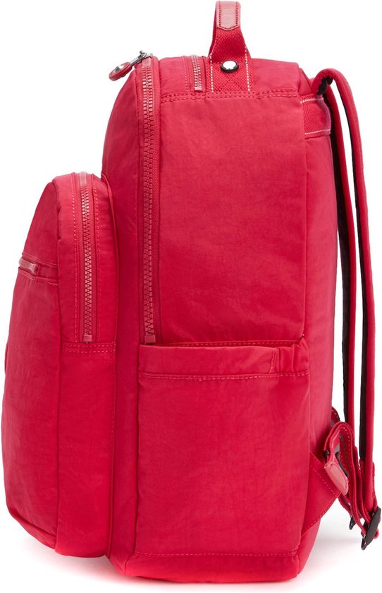 Côté d'un sac à dos Kipling rouge avec poches avant, fermetures éclair et poche latérale.