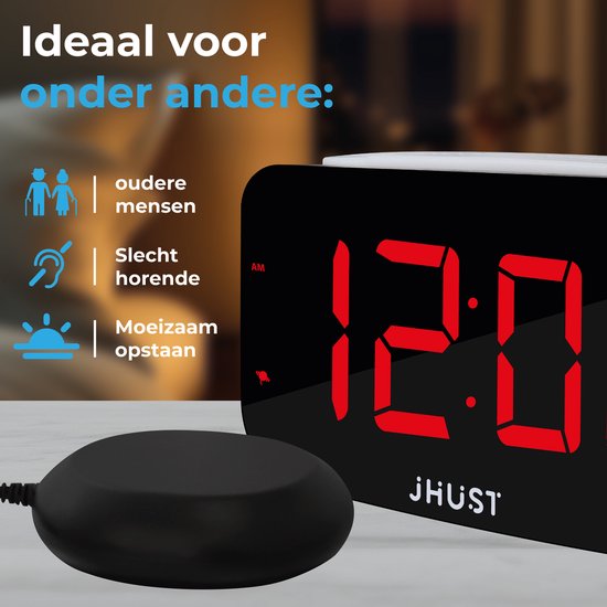 Digitale wekker met rode cijfers toont 12:00, naast een zwarte trilschijf en icoontjes.