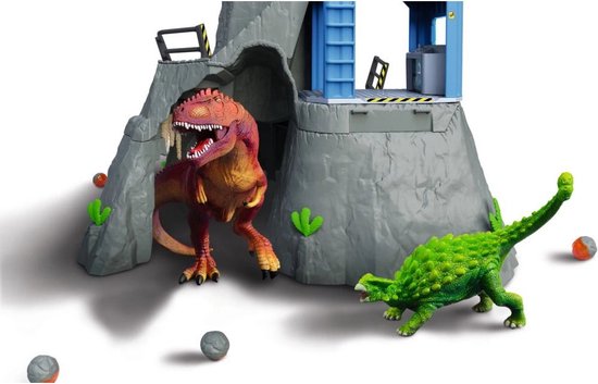 T-Rex en Ankylosaurus speelgoeddino's bij de ingang van een grot van een vulkaan speelset.