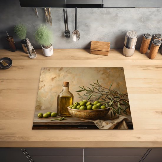 Planche à découper avec nature morte d'olives vertes, bouteille d'huile d'olive et branches d'olivier, sur un plan de travail en bois.