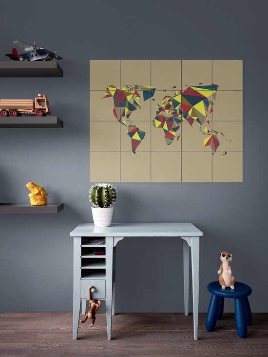 Carte du monde avec des motifs géométriques rouge, jaune et bleu, au-dessus d'un bureau dans une chambre d'enfant.