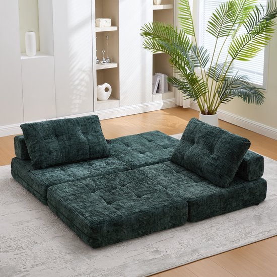 Modulaire smaragdgroene chenillestof bank in een uitgevouwen positie met twee kussens.