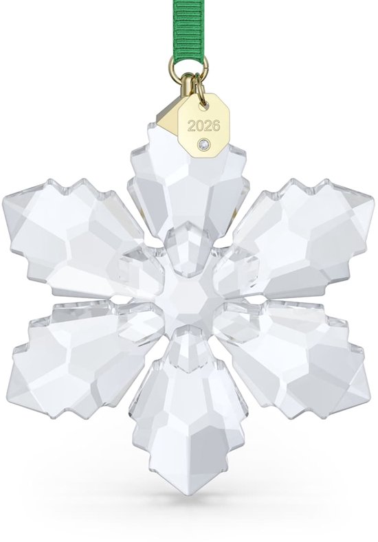 Transparante kristallen sneeuwvlok ornament met groene lint en een gouden bedeltje met '2026'.