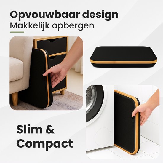 Opvouwbare zwarte wasmand, plat opgevouwen naast een kast en naast een wasmachine.