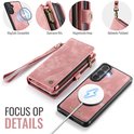 Roze portemonnee telefoonhoesje met polsband, ritssluiting en MagSafe compatibele achterkant.