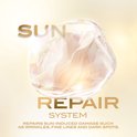 Gouden tekst "SUN REPAIR SYSTEM" over een glimmende, abstracte vloeibare vorm in een bubbel.