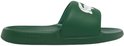 Donkergroene Lacoste slipper met witte krokodillenopdruk op de band.