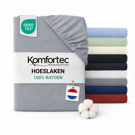 Drap-housse gris 100% coton Komfortec, avec pile d'autres couleurs à l'arrière.
