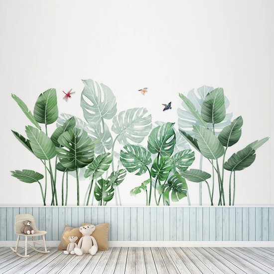 Groene palm- en monstera-bladeren met drie insecten op een witte muur, boven een houten vloer en kinderkamerinrichting.