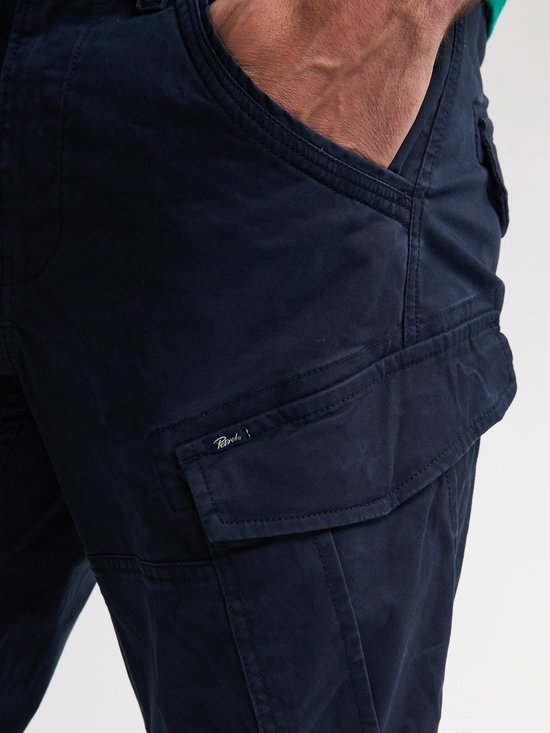 Close-up van de opgestikte cargobroekzak op een donkerblauwe broek met Petrol Industries label.