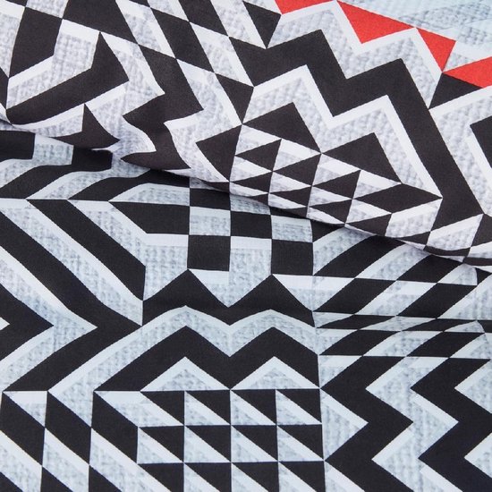 Motif détaillé de formes géométriques noires, blanches et grises avec des accents rouges.
