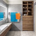 Zilverkleurig inklapbaar droogrek in een badkamer met blauwe en oranje handdoeken.