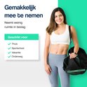 Vrolijke vrouw met sporttas, draagt een sportbeha en legging, met tekst over gemakkelijke meeneembaarheid en geschiktheid voor thuis, sportschool of vakantie.