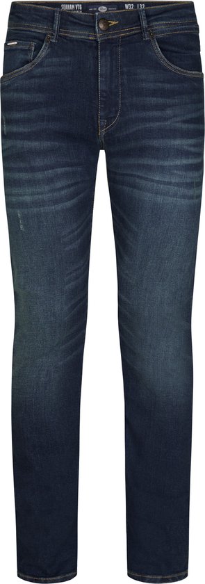 Voorkant van een donkerblauwe spijkerbroek met twee steekzakken en een kleine beschadiging.