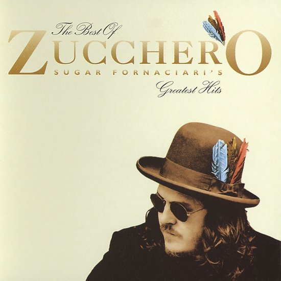Albumcover met de tekst 'The Best Of ZUCCHERO Sugar Fornaciari's Greatest Hits'. Een man met hoed en zonnebril kijkt naar rechts.