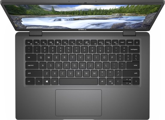 Grijze Dell laptop, open, met zichtbaar toetsenbord, touchpad en scherm met watervalafbeelding.