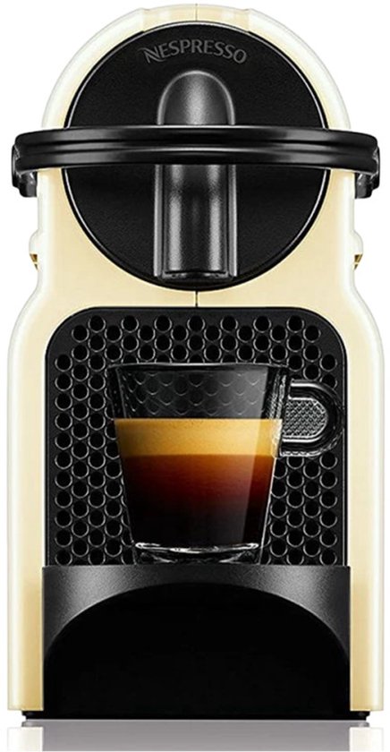 Machine à café à capsules Nespresso Inissia crème avec une tasse d'expresso.