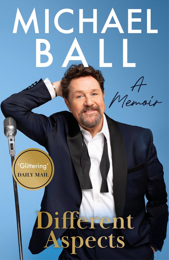 Michael Ball in een tuxedo met losgeknoopte vlinderdas naast een microfoonstandaard. Boektitel: Different Aspects.