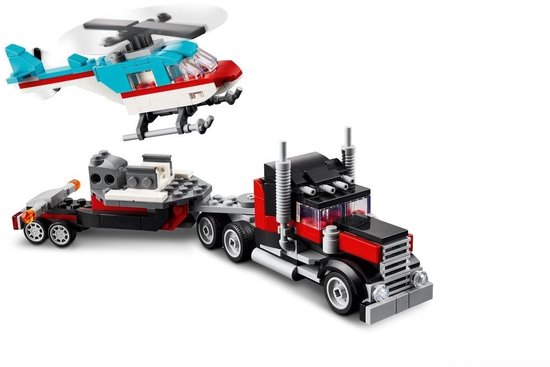 LEGO Creator 3in1 vrachtwagen met helikopter. De vrachtwagen is zwart met rode details, de helikopter is blauw met witte en rode strepen.