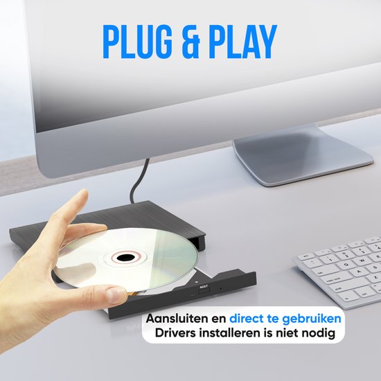 Une main tient un CD au-dessus d'un lecteur DVD externe noir à côté d'un ordinateur.