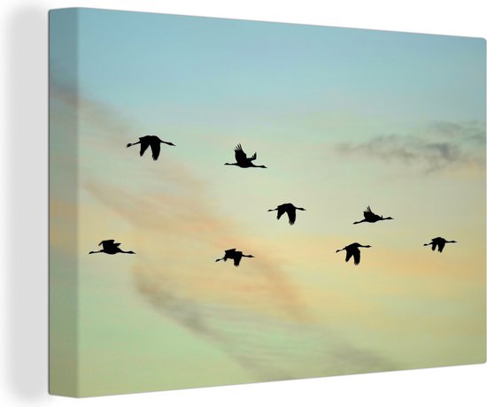 Tableau sur toile Un ciel bleu-jaune avec huit grues - 90x60 cm - Décoration murale