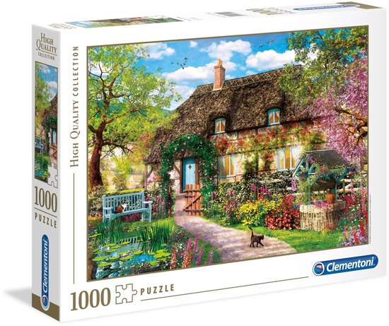 Doos van een 1000-delige puzzel met afbeelding van een schilderachtig plattelandshuisje met rieten dak, bloeiende tuin en vijver. "High Quality Collection" en "1000 PUZZLE".