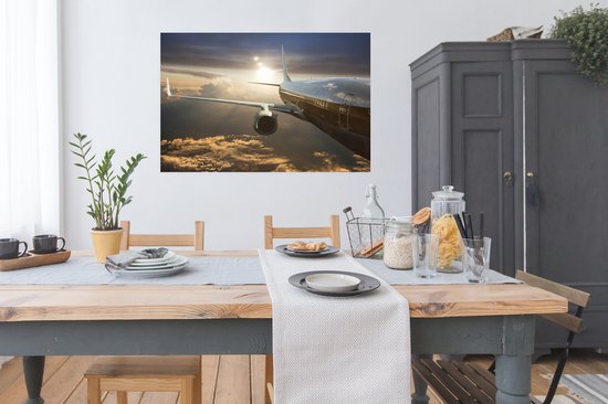 Un avion à réaction survole les nuages Poster 120x80 cm - Tirage photo sur Poster (décoration murale salon / chambre)