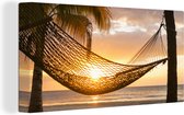 Canvas Schilderij Hangmat op strand tijdens zonsondergang in Jamaica - 160x80 cm - Wanddecoratie