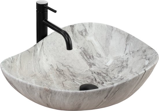 Lavabo ovale avec imprimé marbre et robinet noir sur fond blanc.