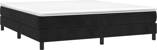 Zwart boxspringbed met witte matras en vier ronde poten.