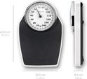 Balance corporelle analogique avec plateau de pesée noir et bord blanc. Mesure jusqu'à 140 kg.