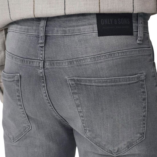 Close-up van de achterkant van een grijze jeans met label 'ONLY & SONS'.