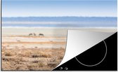 KitchenYeah® Inductie beschermer 81.6x52.7 cm - Een cheeta Nationale Park Etosha - Kookplaataccessoires - Afdekplaat voor kookplaat - Inductiebeschermer - Inductiemat - Inductieplaat mat